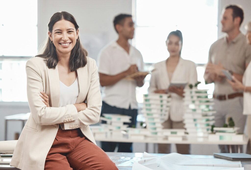 Portrait, smile and happy woman or architect at seminar, training workshop or business meeting. Eng